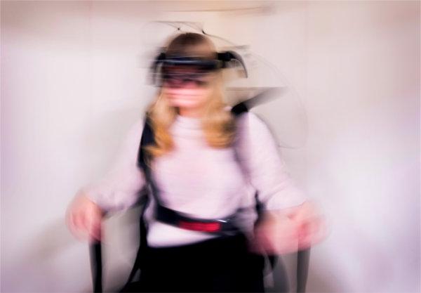 Kaitlyn Kinch, an audiology graduate student, sits in a spinning chair to demonstrate the new services offered at the community hearing clinic